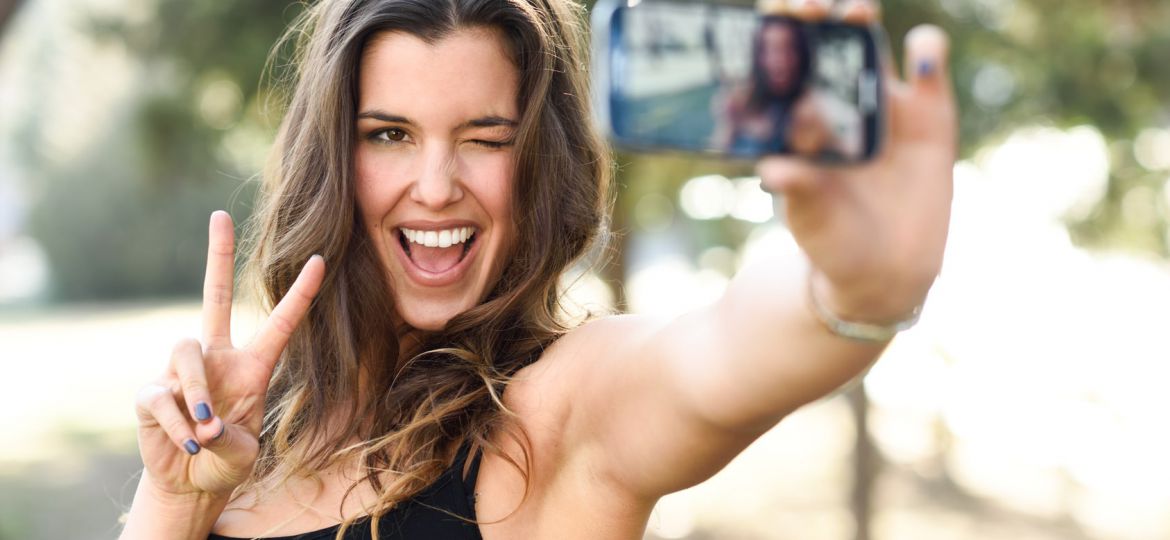 Beautiful young woman selfie in the park