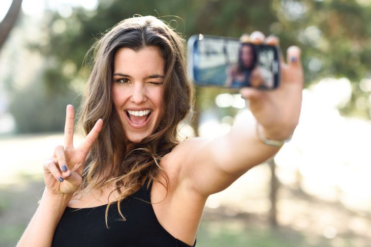 Beautiful young woman selfie in the park